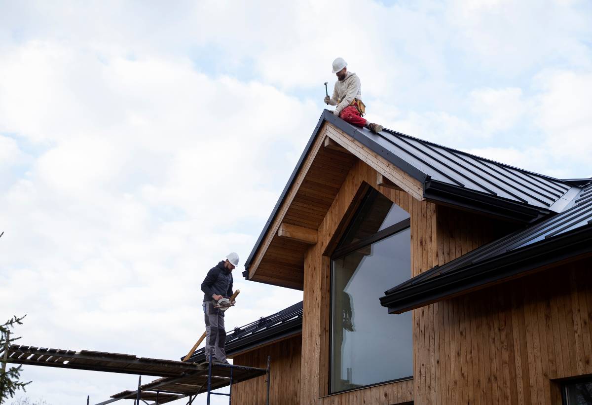Long shot men working on roof